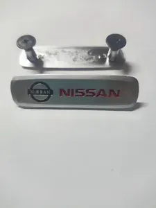 Шильдик(логотип) металлический NISSAN для автоковриков,сумок 2 шт